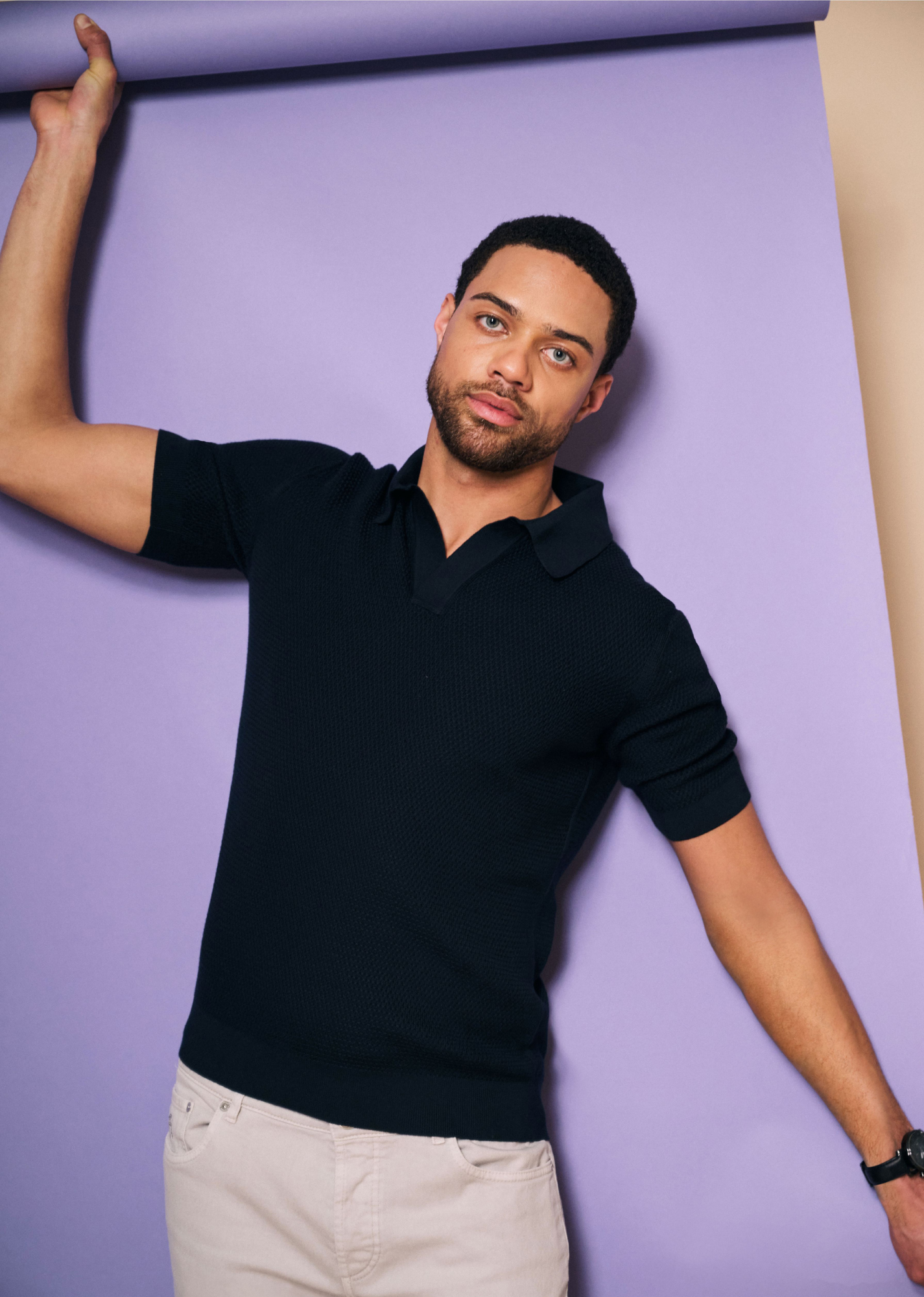 navy blue polo shirt with a purple paper roll background